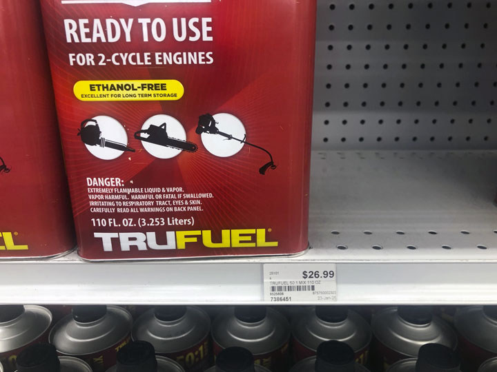 Gallon cans stacked on a shelf showing price of $28