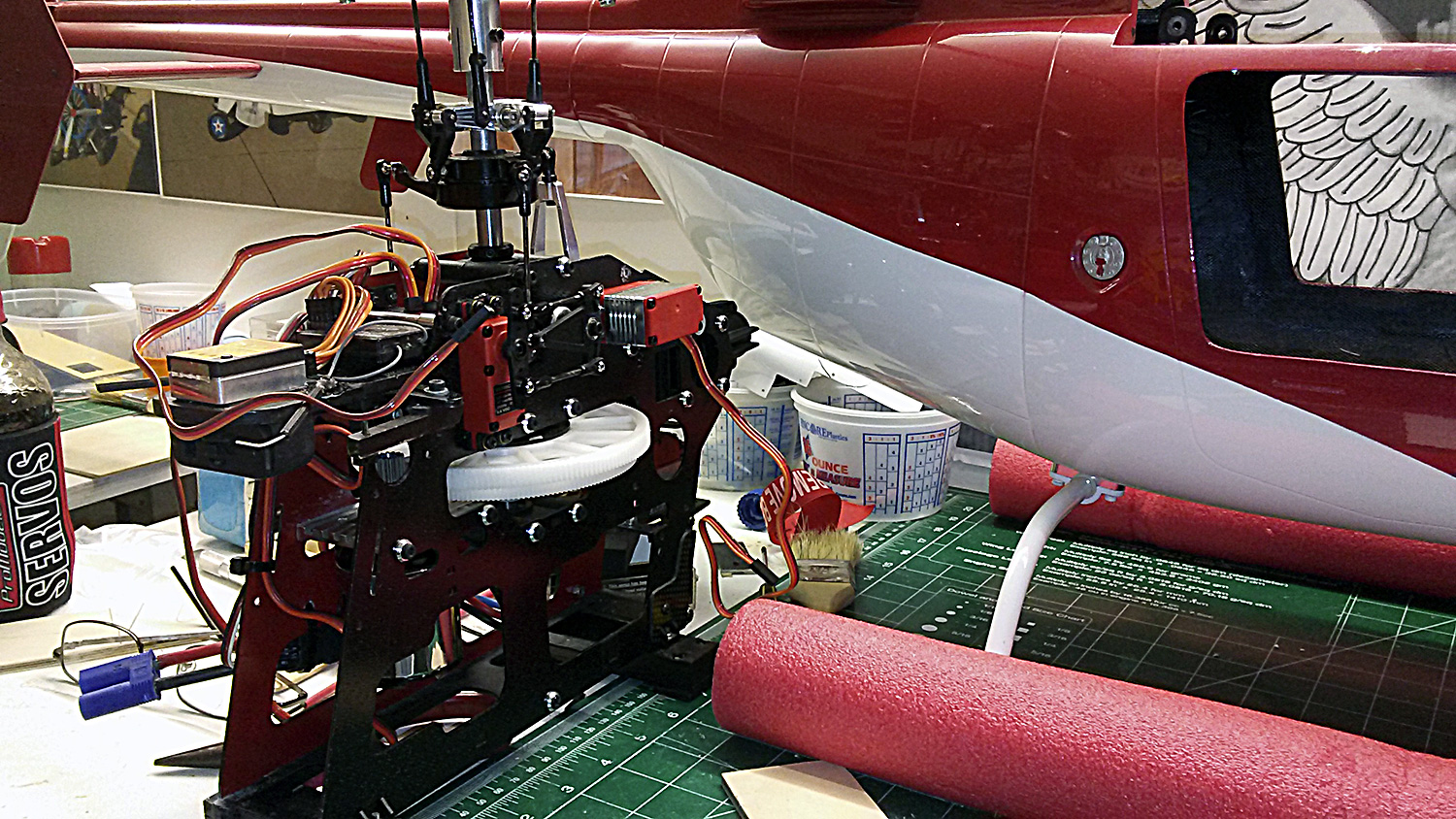 Photo of model helicopter mechanics for red and white Bell Jet Ranger fuselage outfitted with ProModeler servos