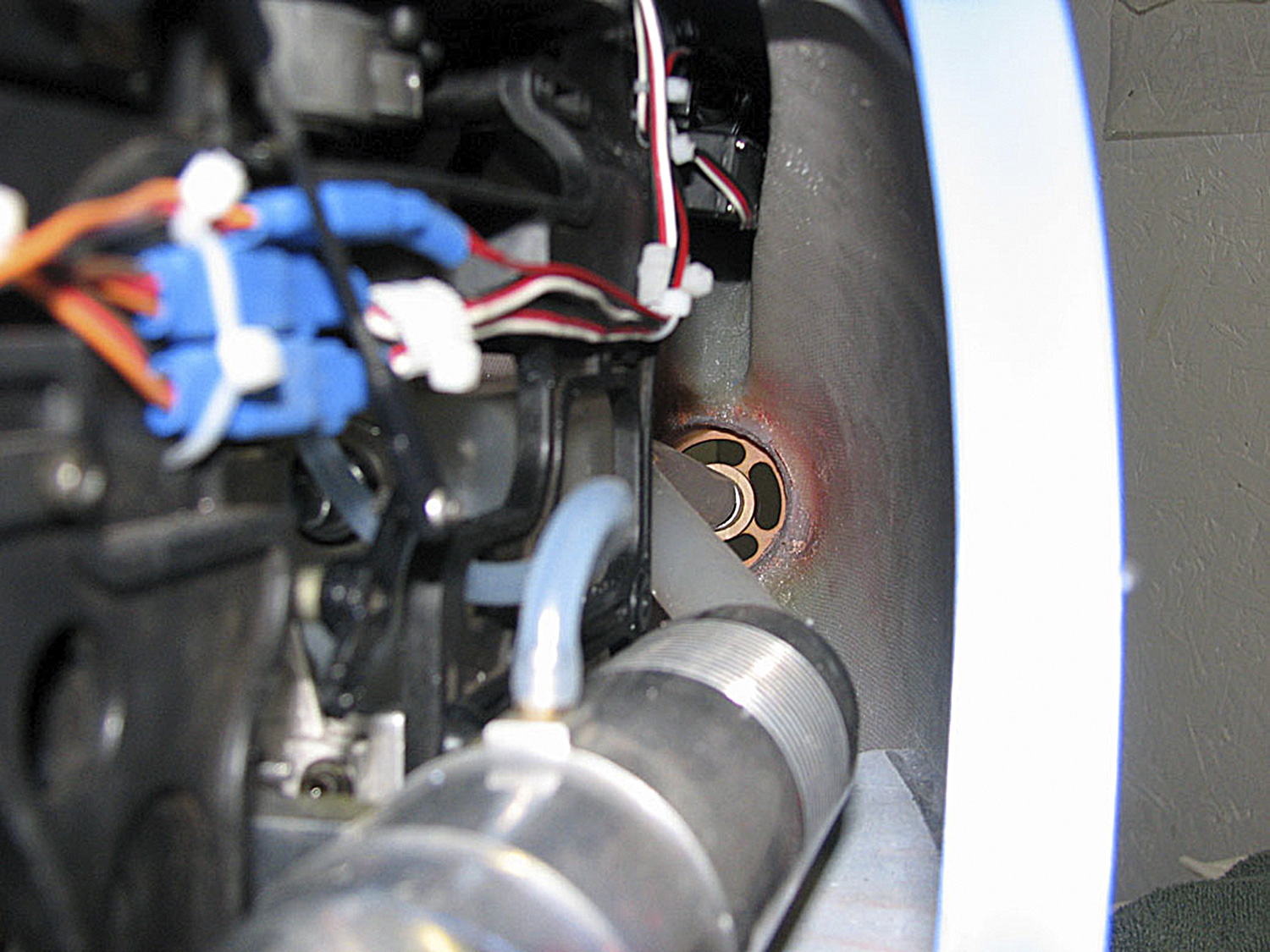 Photo looking down the aft fuselage of the Funkey Hughes 500 showing the silicone tube routing exhaust fumes out of the model
