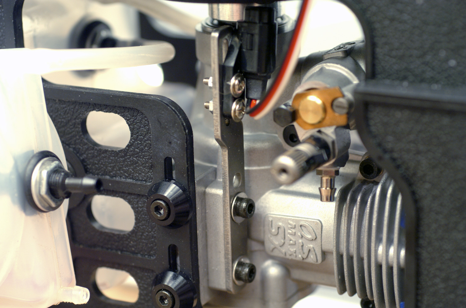 Close up of a hall effect sensor mounted to an OS Max helicopter engine as the pickup to a governor unit
