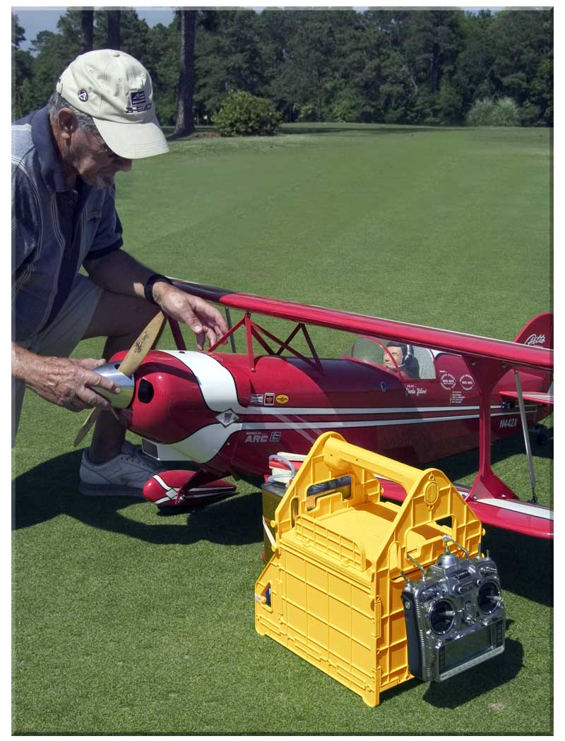 Gene kneels besides a red Great Planes 1/3rd scale Pitts Special biplane with ProModeler PDRS0050 ProTote in foreground
