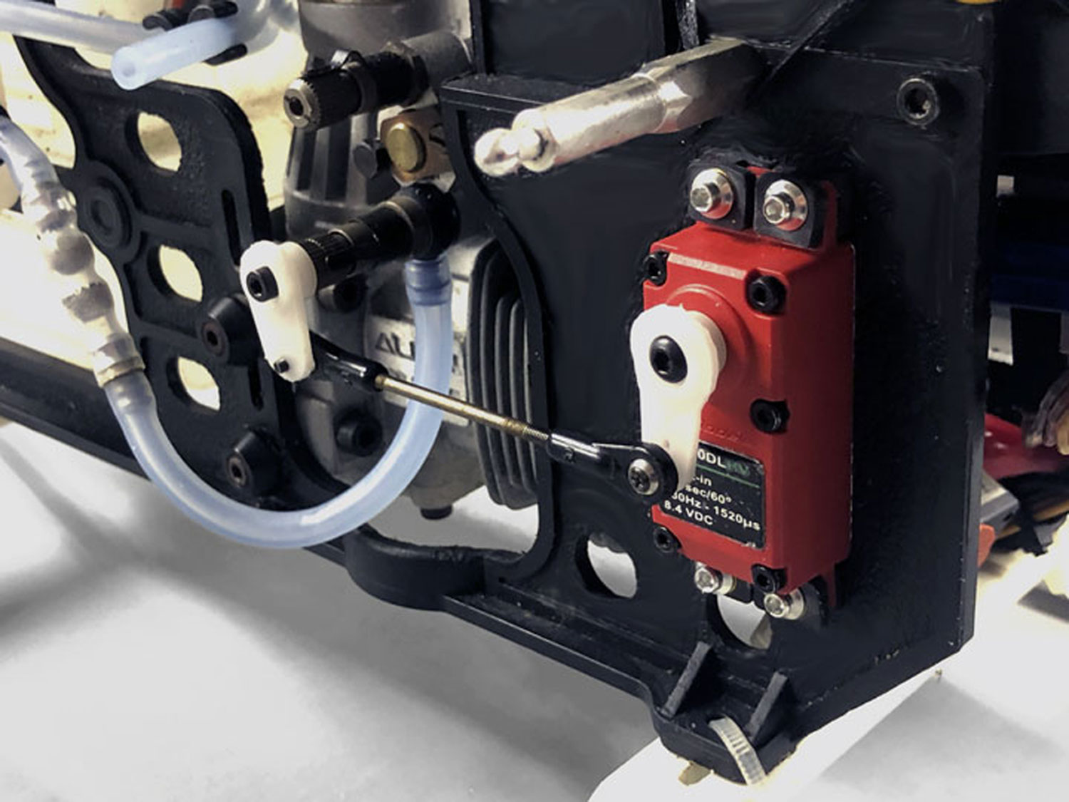 Close up of Align nitro engine mounted with Pantera P6 showing a ProModeler DS90DLHV connected to the needle valve for adjusting fuel mixture on-the-fly