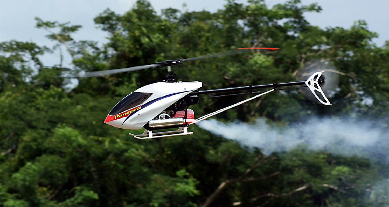 Photo of a Pantera P6 in fast forward flight  going left to right against a backdrop of trees