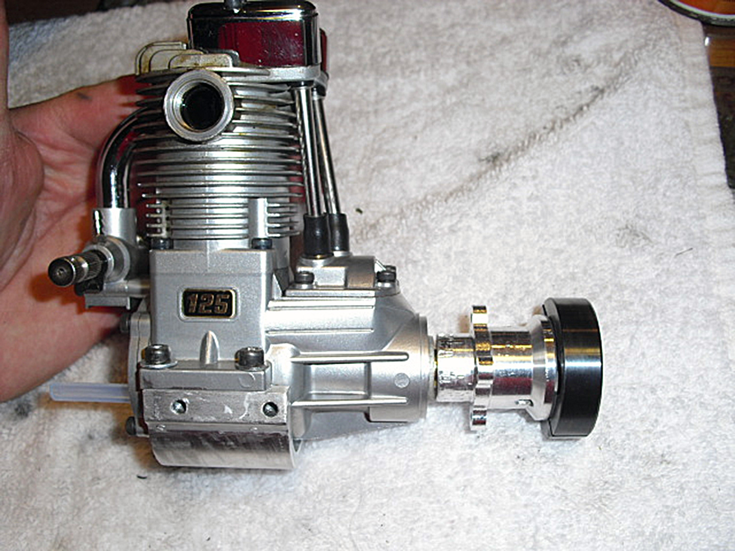 Photo of hand-held Saito 125 fitted to an Audacity Models BBC engine mount along with AUD0037 Tiger 50 fan hub