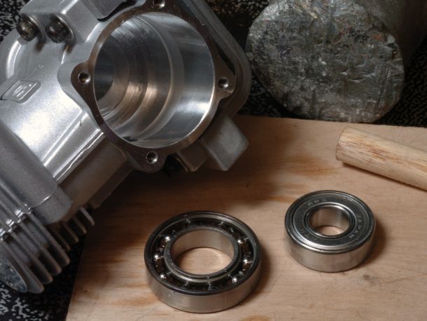 Photo of rear of engine with used bearings setting besides it